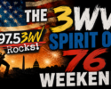 Promotional poster for 3WV Weekend: US flag, fireworks, guitarist silhouette, and bold text '97.5 3WV Rocks!' with 'Spirit of 76' and 'Weekend'