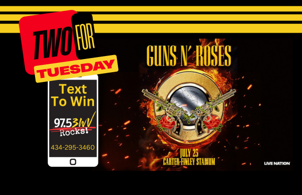 Promotional banner for Guns N' Roses: 'Two for Tuesday' promo with a phone-shaped graphic reading 'Text To Win' and 97.5 Rocks, plus flames and crossed guitars surrounding the band's logo.